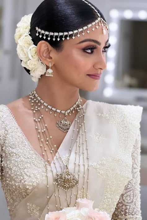 Find the best bridal makeup artists in your budget & desired city with contact information, portfolio & trusted reviews at Weddingbazaar - Trusted Wedding Services for Every Indian Wedding! #southindianwedding #southindianbride #southindianbridemakeup #southindianbridemakeuplook #southindianbridemakeover South Indian White Sari Look, White Dress Indian Wedding, Jewellery On White Saree, White Saree Jewellery Ideas, Sri Lanka Wedding Dress, Bridal Kandyan Saree, Bridal Saree Sri Lankan, White Sarees For Wedding, Sri Lankan Bridal Saree