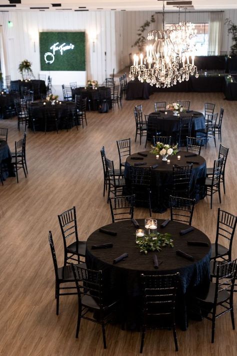 All black table scapes at the reception. Black chairs, black napkins, black table cloths Black Gala Decorations, Black Table Cover Wedding, Centerpieces On Black Tablecloths, All Black Wedding Centerpieces, Simple Wedding Centerpieces Black Tablecloth, Black Tables Weddings, Black Tablecloth Decor Wedding, Black Tablecloth Centerpiece Ideas, Black Wedding Esthetics