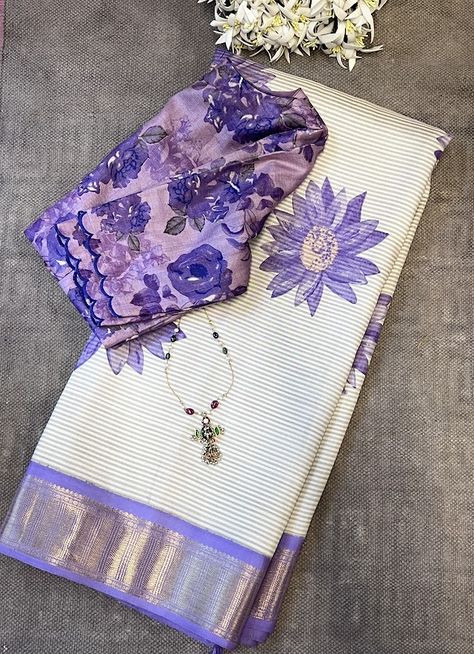 Mila cream lilac kanchipuram silk saree - Milas are as much about the weave as they are about the hand prints and textures that happen as a result of it. This extraordinary Kai Korvai pure Kanchipuram silk saree showcases diagonal cream and grey woven stripes across the body, complemented by a subtle yet substantial pure zari handwoven border and pallu in lilac. Adorned with beautiful purple sunflowers in shaded colors handprinted onto this magnificent saree, it exudes an exquisite contemporary touch, making it a versatile and one-of-a-kind choice for your wardrobe. To view more similar milas, pls click on https://aavaranaa.com/product-tag/mila/ Purple Contrast Color Combinations Dress, Saari Collection, Purple Contrast Color, Normal Saree, Purple Sunflowers, Mangalagiri Pattu Sarees, Aesthetic Saree, Lenin Sarees, Partywear Sarees