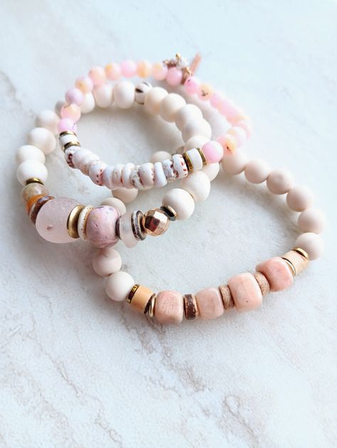 These pink stack bracelets have a fresh feel to them. Stunning Peach Moonstone Cubes, Alabaster bone rondelle beads, recycled glass inblush pink, sea shells, Pink Opal, matte Riverstone, Gold Hematite, and more. Mix in soft camel shell heishi beads, ethical bone beads, Ethiopian metals,African  Recycled Glass beads, aromatic fused glass beads, and several mixed metal spacers. Beautiful and feminine and yet casual enough for everyday. Strong elastic cording. The item/s pictured is the item you wi Cheap Beach Jewelry With Gemstone Beads, Everyday Pink Beaded Bracelets With Natural Stones, Bohemian Beaded Bracelet With Rose Quartz, Bohemian Hand-strung Rose Quartz Beaded Bracelets, Bohemian Rose Quartz Beaded Bracelet With Natural Stones, Pink Sea Shells, White Beads Bracelet, Stack Bracelets, Stack Bracelet