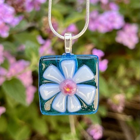 "Fused Glass Flower Necklace in assorted beautiful colors!  Please choose your transparent background in blue, turquoise, aquamarine, or lavender. The petals in white or pink/white, and your special millefiori center in blue, pink, or yellow (see 2nd pic for some of the options).  This pendant was Contour fused for a beautiful texture. Each piece retains its individual character, while edges are soft and rounded.  The pendant is mounted on silver plated leaf bail and comes with an 18\" silver pl Fuse Glass Jewelry, Fusible Glass Projects, Fused Glass Inspiration, Fused Glass Jewelry Ideas, Fused Glass Pendants Ideas, Small Fused Glass Ideas, Glass Fusing Jewelry, Fused Glass Magnets, Fused Glass Projects