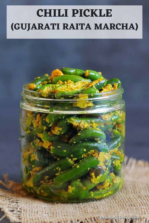 Gujarati Pickle Raita Marcha is super easy to make from scratch, tasty to the core, and requires a few basic staple ingredients. This is a vegan, and traditional-style Hari Mirch ka achar recipe. This Gujarati-style Chilli pickle is my favorite condiment. It can be made any time of the year. This green chilli pickle tastes amazing with thepla, paratha, roti, rice, khakhra, fafda gathiya, or just about anything. It’s tangy, pungent, a little bit spicy, and flavorful, and helps enhance the taste o Chilli Pickle Recipe, Mirch Ka Achar, Indian Pickle Recipe, Achar Recipe, Green Chilli Pickle, Chilli Pickle, Pickle Recipes Homemade, Make From Scratch, Recipe Cover