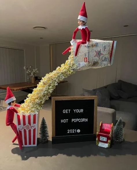 Make your movie night more fun with this Elf on the Shelf character. It shows two elves pouring popcorn in preparation for the show. Source: Pinterest #ElfOnTheShelfIdeas #HolidayElfFun #ElfMischief #CreativeElfScenarios #ChristmasElfPranks #ElfAdventures #ElfOnTheShelfActivities #FamilyElfTraditions #ElfAntics #ElfPoses Movie Night Elf On The Shelf Ideas, Elf On The Shelf Popcorn Movie Night, Movie Night With Elf On The Shelf, Elf On The Shelf Christmas Movies, Elves And Popcorn, Elf On Shelf Popcorn Ideas, Elf Tightrope, Elf On The Shelf Ideas With Popcorn, Elf On Shelf Popcorn