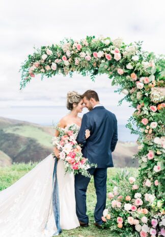 Frame the moment and capture the view of your outdoor wedding ceremony with a creative and unique crescent-shaped floral wedding arch backdrop like this.  #weddingarch #outdoorweddingarch #weddingarchideas #wedding #confettidaydreams #weddingceremony #weddings #weddingideas #weddingplanning #weddingcanopy #weddingbackdrop Wedding Balloon Arch, Half Crescent Moon, Copper Wedding Arch, Metal Backdrop, Lilac Wedding Bouquet, Wedding Arches Outdoors, Romantic Outdoor Wedding, Mountain Top Wedding, Bee Flower