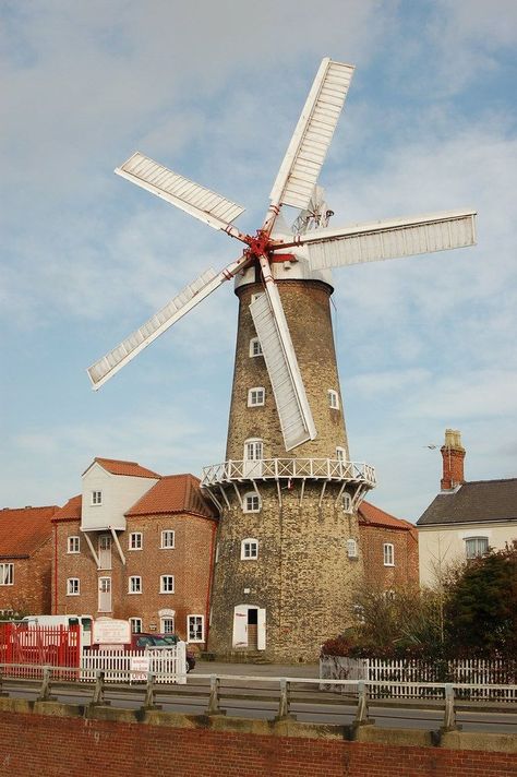 Maud Foster Windmill, Skirbeck, Boston, Lincolnshire, UK, is a seven-storey, five sail windmill and is one of the largest operating windmills in England at 24.38m tall to the cap ball. The mill was built in 1819 and was repaired and restored in 1988. The seven-stage mill tower is constructed in gault brick and has Yorkshire sash windows with segmental heads on each level. It is topped with an ogee cap of white painted timber and canvas with five sails and a fan tail. Sash Windows, The Mill, White Paints, Yorkshire, Lighthouse, Eiffel Tower, The Fosters, Sailing, Boston