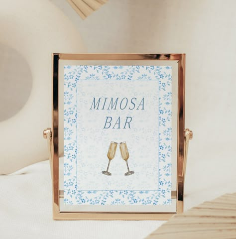 "The Something Blue Bridal Shower Mimosa Bar Sign Template is the perfect detail for a Something Blue bridal shower! The template features blue floral artwork and fully editable text. Our mimosa bar sign is editable and is perfect for a bridal brunch, tea with the bride-to-be, or a something blue before the bride says I Do shower. The templates are easy to customize, download and print at home within minutes, through Templett - a free software that you can access through your regular web browser on your computer. No need to install any fonts or special software. Easy as cake! *No Physical Item will be Sent - This is a Template* Included sizes: * 5x7\" * 8x10\" ⭐ MATCHING ITEMS https://www.etsy.com/shop/SophiaMariePaperie?ref=seller-platform-mcnav&search_query=B0 TRY A DEMO Try out a demo o Blue And Gold Bridal Shower Decorations, Blue Bridal Brunch, Blue Boho Bridal Shower Ideas, Blue And Gold Bridal Shower Ideas, Something Blue Before I Do Bridal Shower Decor, Bridal Shower Light Blue, Something Blue Wedding Shower Theme, Something Blue Brunch, Something Blue Bridal Shower Ideas Food