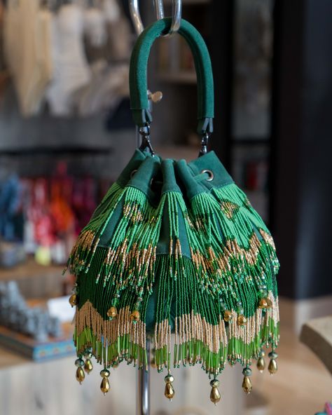 Made by an incredible Mexican designer. This elegant purse is a masterpiece that gives us the perfect mix between the different shades of green with some golden details. Elevate your outfit with it and shine even brighter!✨✨✨⁠ ⁠ Visit our Montage boutique to shop this incredible bag and more! Diy Pouches, Potli Purse, Elegant Purse, Mexico Fashion, Hand Beaded Bag, Hair Highlights And Lowlights, Pouch Diy, Potli Bag, Potli Bags