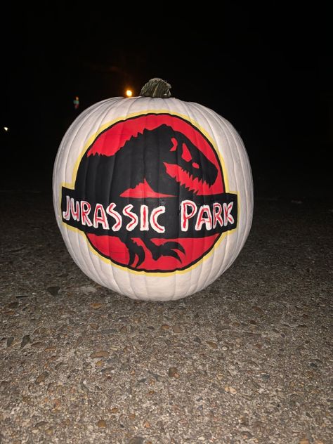 Jurassic World Pumpkin Carving, Dino Pumpkin Painting, Dinosaur Painted Pumpkin, Jurassic Park Pumpkin, Pumpkin Painting Ideas Dinosaur, Dinosaur Pumpkin Painting, Dinosaur Pumpkin Decorating Ideas, Jurassic Park Logo, Amazing Pumpkin Carving