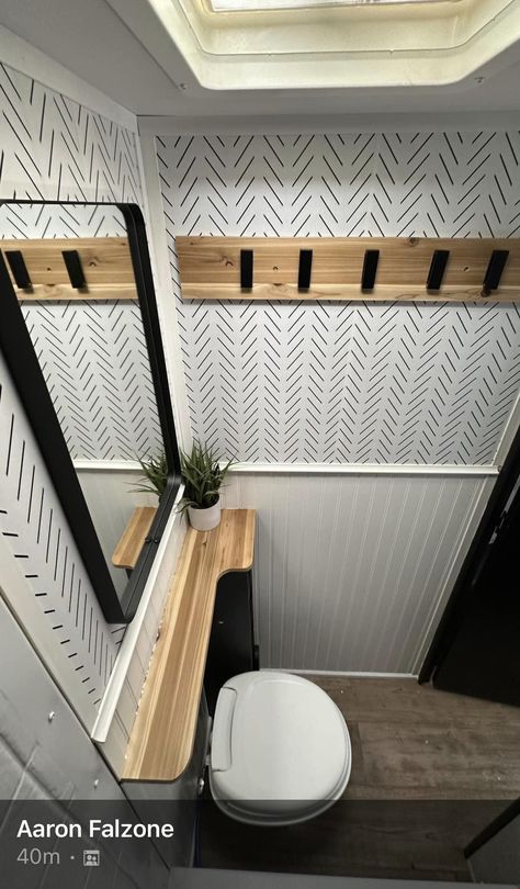 Camper Bathroom Wallpaper, Easy Diy Camper Remodel, Minimalist Camper Living, Remodeled Camper Bathroom, Holiday Trailer Renovations, Camper Set Up Ideas Outside, Black And White Rv Remodel, 5th Wheel Bathroom Remodel, Black And White Camper Interior