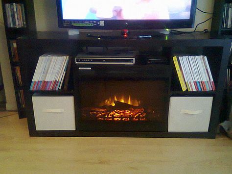 I know. Amish fireplace? Tacky. But when one doesn't have heat that thing is awesome. I wonder if this idea would work with mine... Caramel Couch, Ikea Media Console, Bookshelf Ikea, Fireplace Bookshelf, Ikea Hack Living Room, Hackers Ikea, Fireplace Media Console, Tv Hacks, Bed Ikea