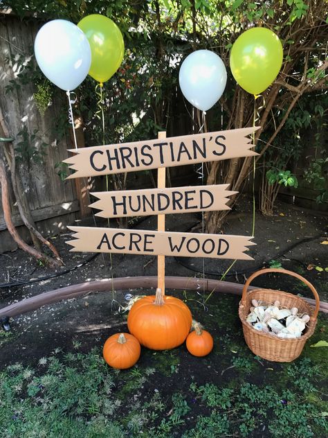 DIY Hundred Acre Wood sign: made by my hubby :) Basket held the party favors Hundred Acre Wood Birthday, Hundred Acre Woods Decorations, Hundred Acre Woods Party, Winnie The Pooh Signs Diy, Diy 100 Acre Wood Sign, Hundred Acre Wood Sign Diy, Diy Hundred Acre Wood Sign, 100 Acre Wood Sign, Hundred Acre Woods Sign