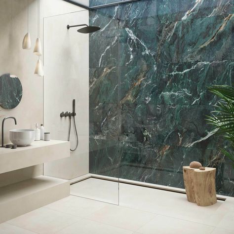 Discover the elegance of the Deluxe Green tile, a bold statement in luxury with its striking dark green marble effect and detailed, multi-tonal veining that adorns its highly polished, porcelain build. Perfect for creating an opulent atmosphere on interior walls and floors, these large format 1200x600mm tiles, with a 10. 5mm thickness, promise durability and timeless beauty. Tiled Floor And Wall Bathroom, Onyx Tile Bathroom Wall, Green Porcelain Tile Bathroom, Bathroom With Dark Green Tiles, Feature Shower Wall Tiles, Green Marble Tiles Bathroom, Large Green Tile Bathroom, Bathroom Ideas Green And Gold, Marble Feature Wall Bathroom