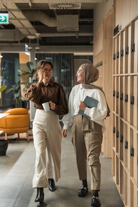 Two women walking down a hallway in an office building · Free Stock Photo People In Office Photography, Working With Women, Office Workers Photography, Casual Corporate Photoshoot, Office Photo Shoot Ideas, Office Team Photoshoot Ideas, Company Group Photo, Office Shoot Ideas, Group Office Photos