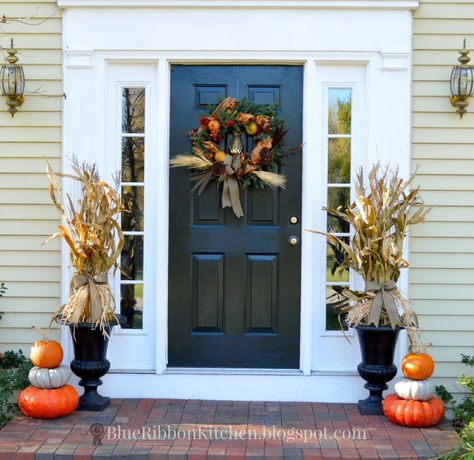 This fall porch with stacked pumpkins and corn stalk filled urns offers a friendly autumn welcome without being too fussy or requiring too much effort. Corn Stalks Decorations, Corn Stalk Decor, Fall Urn, Outside Fall Decor, Easy Fall Wreaths, Corn Stalks, Fall Front Porch Decor, Halloween Front Porch, Stacked Pumpkins