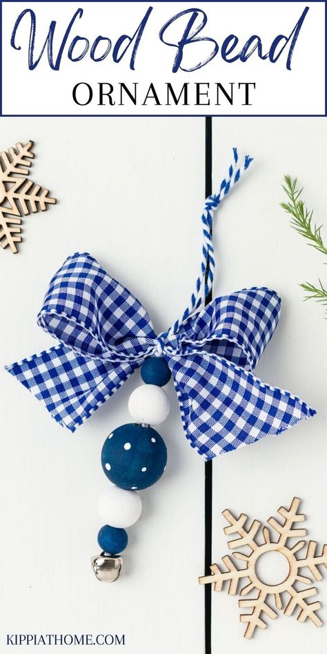 Blue and white wood bead ornaments on a white table Wood Bead Garland Diy Christmas, Wood Bead Christmas Ornaments Diy, Beaded Christmas Decorations Diy, Wood Bead Crafts Diy, Diy Christmas Ornaments Gifts, Crafts With Wooden Beads, Wood Bead Ornaments Diy, Bead Christmas Ornaments Diy, Bead Ornaments Diy