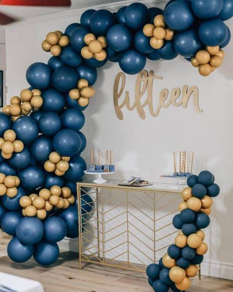 Upgrade your 15th birthday celebration with a fantabulous dessert table setup using top notch decor accessories. Arrange your yummy confections over stylish white cake stands and adorn them with chic paper straws to add a glamorous appeal to your display. Moreover, accentuate your backdrop wall with a charming balloon garland created with gold and navy blue balloons for a magical appeal. Blue And Gold Backdrop, Birthday Dessert Table, Party Decorations Table, Balloons Cake, Dessert Table Birthday, Birthday Dessert, Backdrop Wall, Gold Backdrop, Dessert Table Decor