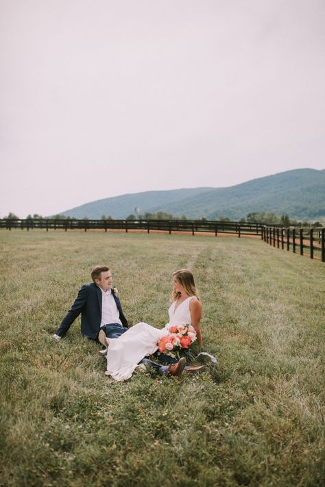 A couple on their wedding day sitting in the grass in the foothills of the Blue Ridge Mountains at King Family Vineyards in Charlottesville, Virginia. Blue Ridge Engagement Photos, Blue Ridge Mountains Virginia, Mountain Destination Wedding, Photographer Couple, Jean Photography, Mountain Destinations, Florals Wedding, Charlottesville Virginia, Arizona Photographer