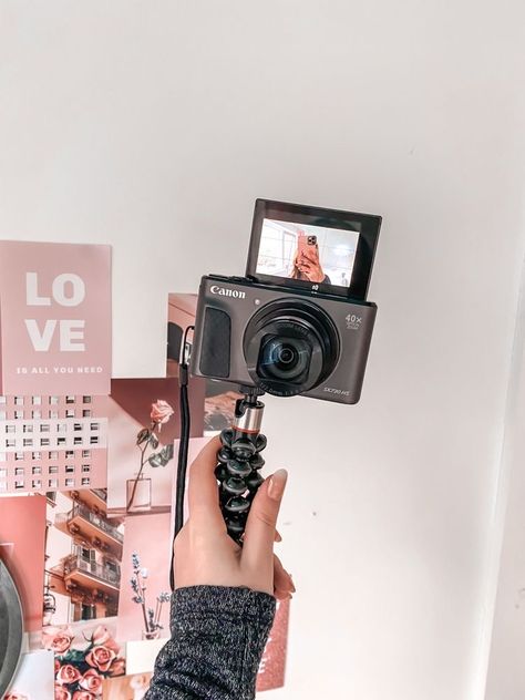 girl holding camera on tripod in front of pink backdrop Vlogging Aesthetic, Best Vlogging Camera, Kamera Dslr, Canon G7x Mark Ii, 2024 Moodboard, Lauren Asher, Youtube Channel Ideas, Dirty Air, Vlogging Camera