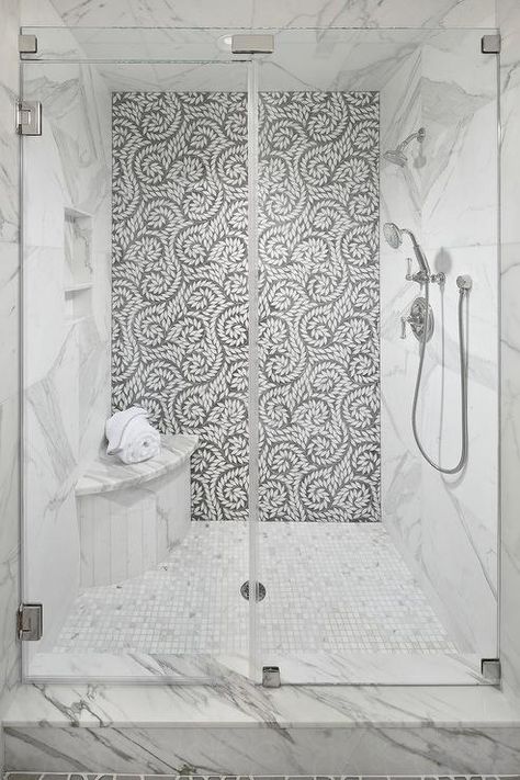 A seamless glass walk-in shower boasts a curved marble shower bench fixed on marble grid floor tiles beneath a tiled niche framed by a marble surround. Corner Shower Seat, Small Shower Remodel, Marble Showers, Shower Seat, Shower Niche, Shower Bench, Bathroom Shower Tile, Bathroom Remodel Shower, Corner Shower