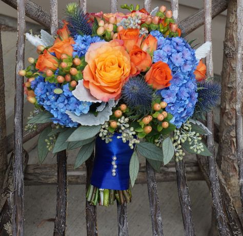 I had so much fun designing this blue, orange and peach bouquet! Flowers are hydrangeas, Free Spirit Roses, peach hypericum berries, Spray Roses and lush seeded Eucalyptus (flowerartistry.ca) Feb Wedding Flowers, Light Blue And Orange Wedding Bouquet, Navy And Orange Wedding Flowers, Cornflower Blue And Orange Wedding, Orange And Blue Centerpieces, Prom Bouquet Ideas Color Schemes, Blue And Orange Bouquet, Orange And Blue Bouquet, Peach Hypericum