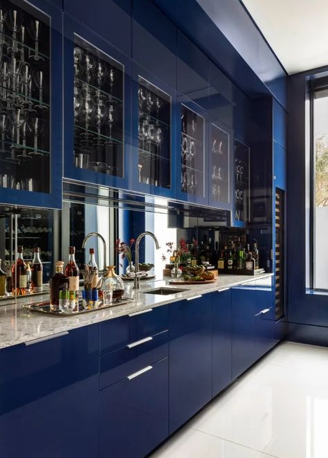 This oversized bar leaves quite the impression. Featuring a custom, high gloss, floor-to-ceiling blue lacquer with integrated refrigerator drawers, an ice maker, and a wine cooler.⁠ ⁠ High Gloss Blue Kitchen Cabinets, Dojo Design, High Gloss Kitchen Cabinets, Gloss Kitchen Cabinets, Integrated Refrigerator, High Gloss Kitchen, South American Art, Gloss Kitchen, Kitchen Finishes