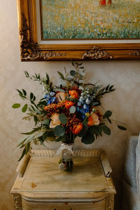 Blue And Rust Wedding Bouquet, White Orange Blue Wedding Bouquet, Wedding Bouquets Blue And Orange, Blue Fall Wedding Bouquets, Fall Blue Bouquet, Terracotta And Blue Bouquet, Simple Colorful Floral Centerpieces, Blue Fall Flower Arrangements, Bold Fall Wedding Colors