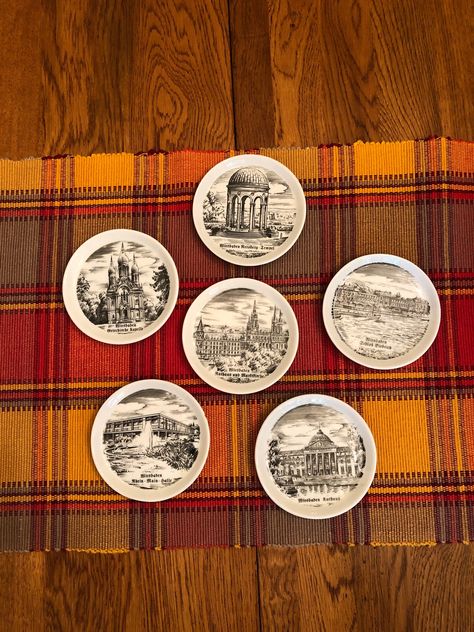 Vintage glass coaster set in a black wrought iron type caddie. 6 coasters in the set.   Each coaster measures Each coaster depicts a famous German building. Wiesbaden - the Biebrich Palace and Wiesbaden Kurhaus   to name twoplease see the photos to view addition buildings/landmarks. One coaster has what I would describe as a flea biteit was  very difficult to capture in a pictureplease see pic #10. One coaster has a small nickplease see pic #7. Overallthese coasters are in good vintage condition Glass Coaster, Glass Coasters, Wrought Iron, Coaster Set, Palace, Etsy Gifts, Barware, Coasters, Paper Party Supplies