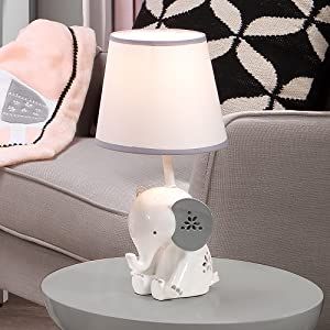 Style Modern Brand Lambs & Ivy Color White Product Dimensions 7"D x 7"W x 14.25"H Light Source Type Incandescent Polyresin Custom designed white resin elephant lamp with gray ears and floral details Soft white lamp shade with gray trim adds the perfect finishing touch This “grow with me” lamp can be enjoyed by your little one for years to come Adds a designer touch to your baby or child's room Includes an energy-efficient light bulb which uses less energy than a standard incandescent bulb Grey Elephant Nursery, Mini Crib Bedding, Elephant Lamp, Wall Decor Storage, Lambs & Ivy, Toddler Bed Set, Nursery Lamp, Flower Shapes, Gray Trim