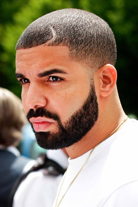 When you think of a Drake haircut, you can hardly name one only. The rapper changes his style pretty often. Among his most popular 2022 hair looks are Drake waves, a heart design, a line up and an Afro fade. Find more ideas here. #menshaircuts #menshairstyles #drake #drakehair #drakehaircut Drake Beard, Buzz Cut Styles, Hair Parts, Hairstyles For Receding Hairline, Drake Photos, Drake Graham, Boy Haircut, Investment Opportunities, Aubrey Drake