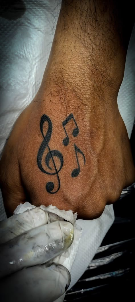 Hand music Tattoo Music Hand Tattoos For Guys, Music Note Hand Tattoos, Rare Men Tattoos, Rnb Music Tattoo, Music Hand Tattoo, Love For Music Tattoo, Small Hand Tattoos For Guys Design, Music Neck Tattoo, Guy Hand Tattoos