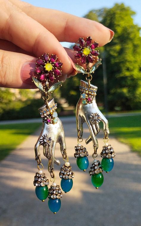 "Whimsical Silver Hands" Those One of a kind, unique design Statement Dangle Earrings, combine vintage charm with contemporary elegance. They are colorful assemblage piece of jewelry featuring silver-colored metal hands delicately embellished with tiny rhinestones that add a touch of sparkle and glamour.   From the tips of the graceful fingers, cascade of vintage rhinestones elegantly dangles, creating a mesmerizing play of light and color. At the end of the cascade are green/blue Jade Czech gla Vintage Mexican Jewelry Novica, Luxury Handmade Retro Jewelry, Collage Jewelry, Assemblage Earrings, Vintage Assemblage Jewelry, Eclectic Jewelry, Whimsical Accessories, Whimsical Jewelry, Blue Jade