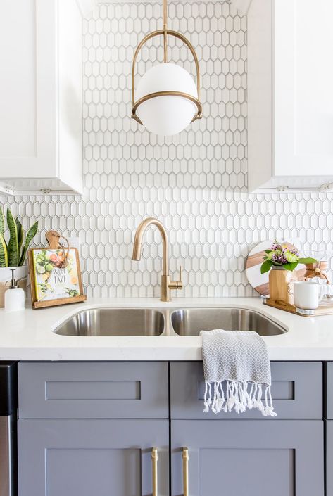 Modern kitchen in small space with brushed brass fixtures and rose accents. Grey base cabinets work perfectly with white quartz countertop. Interior design by Vantage Design Studio in Murietta, CA. Creative Kitchen Backsplash, Backsplash Design, Model Dapur, Unique Kitchen Backsplash, Gray And White Kitchen, Kabinet Dapur, Kitchen Backsplash Designs, Backsplash Designs, Perfect Kitchen