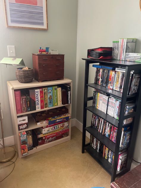 Board games on a shelf with small storage above Short Bookshelf, Board Game Shelf, Game Shelf, Hidden In Plain Sight, Coven, Shelf Organization, Bookshelves, Board Games, Shelves