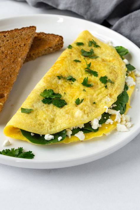 Spinach and Feta Omelet on a white plate. Spinach And Feta Omelette, Simple Omelet, Spinach Omelette, Spinach Omelet, Healthy Breakfast Recipe, Omelets Recipe, Simple Breakfast, Spinach And Cheese, Spinach And Feta