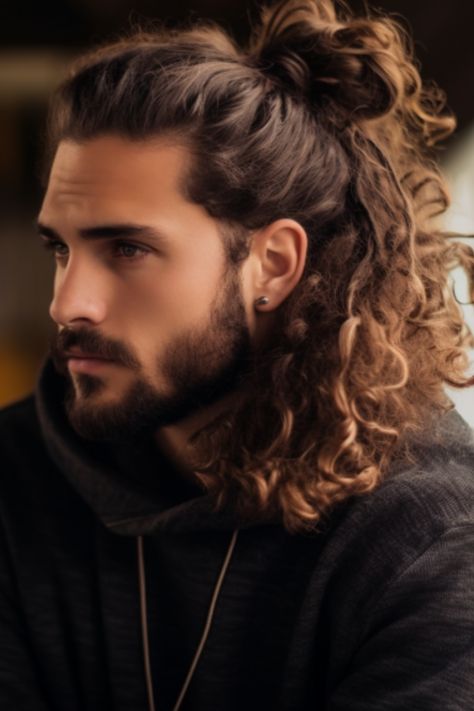 Long curly locks styled into a man bun add a touch to your look. If you have messy curls pulling them up into a man bun at the back of your neck can add an element of sophistication. Click here to check out more best curly hairstyles and haircuts for men. Men Long Hair And Beard Style, Curl Long Hair Men, Curly Hair Men Bun, Man Buns Curly Hair, Long Haired Men Hairstyles, Wedding Hairstyles Men Long Hair, Wedding Hairstyles For Men Long Hair, Long Curly Hair Men Ponytail, Man Bun Wedding Hair