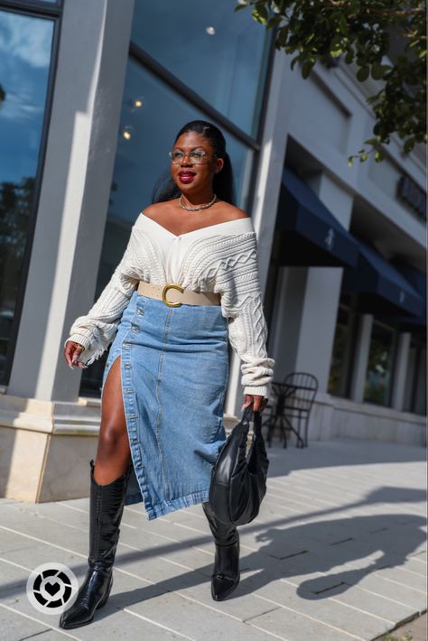 Black woman walking down side walk with black, circular purse in hand. She’s wearing an off-shoulder cream cardigan tucked in a jean skirt with a split and black croc cowboy boots. Plus Size Cowgirl Boots Outfit, Cow Boy Boots Outfit Black Women, Denim Skirt Cowboy Boots Outfit, Plus Size Cowboy Boots Outfit, Cowboy Boots Dress Outfit, Winter Cowboy Boots Outfit, Long Black Boots Outfit, Outfits With Cowgirl Boots, Denim Dress Outfit Fall