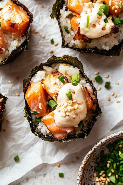 Discover a delicious twist on traditional sushi with these baked salmon sushi cups! These savory treats are perfect for gatherings or as a unique appetizer. The combination of tender baked salmon and seasoned rice is sure to impress your guests. Try making these cute and flavorful sushi cups for your next get-together and watch them disappear in no time! Enjoy the delectable flavors of sushi in a convenient handheld cup - a fun and easy way to enjoy this classic dish. Baked Scallop Sushi Roll, Salmon Bake Sushi, Salmon For Sushi, Sushi Toppings, Salmon Sushi Cups, Baked Salmon Sushi, Sushi Cups, Baked Sushi, Smoked Salmon Sushi