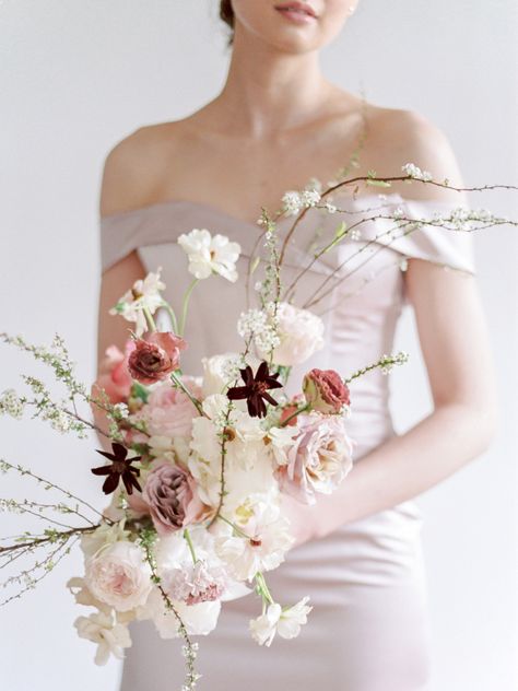 "S" Shape Created by Jules and Pearls Events, this cosmo, Japanese anemone, garden rose, and carnation spray was structured by winding in-bloom branches. #modern #bouquet #flowers #structured #minimalist Nontraditional Bride, Modern Wedding Bouquets, Champagne Color Dress, Modern Bouquet, Blush Bouquet, Wedding Bouquets Bride, Bridal Flowers, Blush Wedding, Brides And Bridesmaids