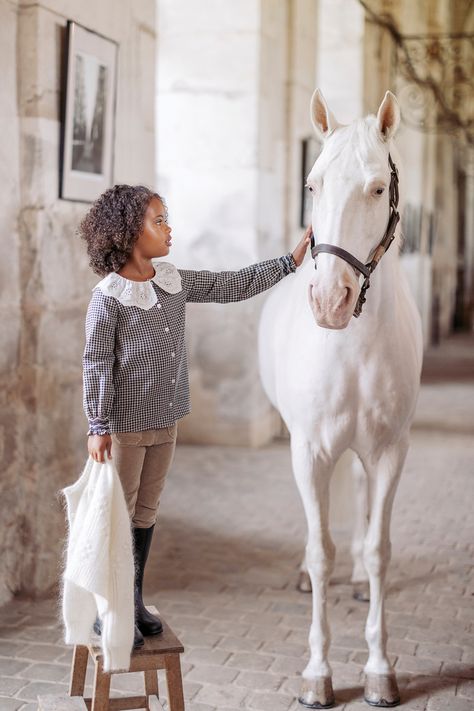 The National Equestrian Academy of the Domaine de Versailles opens its doors to Tartine et Chocolat. The magic happens with the sound of hooves on the paving stones and the smell of leather in the saddlery. This prestigious place full of history invites the children to dream. #tartineetchocolat #fashion #kidsfashion #ecuriedeverailles #versailles #automn #winter Trousers For Girls, Raw Denim Jeans, Elegant Clothing, School Collection, Corduroy Trousers, Paving Stones, Raw Denim, Navy Shirt, Lace Collar