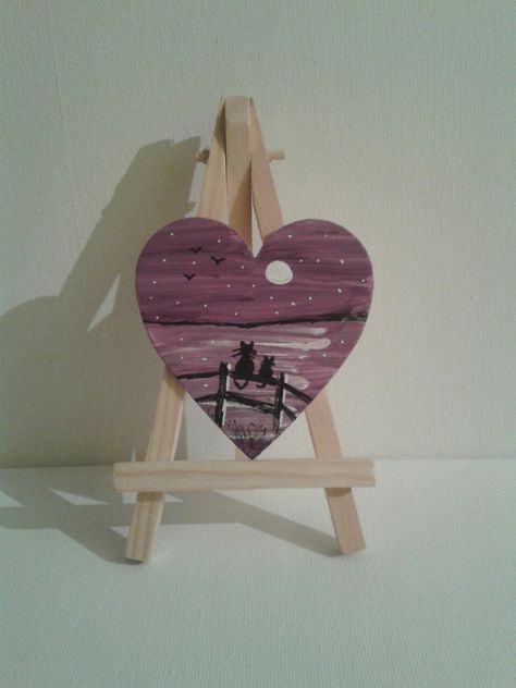 Cat silhouette on a fence painted on wooden heart Painting On Heart Shaped Wood, Painting On A Heart Shape Canvas, Heart Wood Painting, Painted Wood Hearts, Heart Shaped Painting, Painted Hearts On Wood, Wooden Heart Painting Ideas, Heart Shaped Canvas Painting Ideas, Wood Heart Crafts