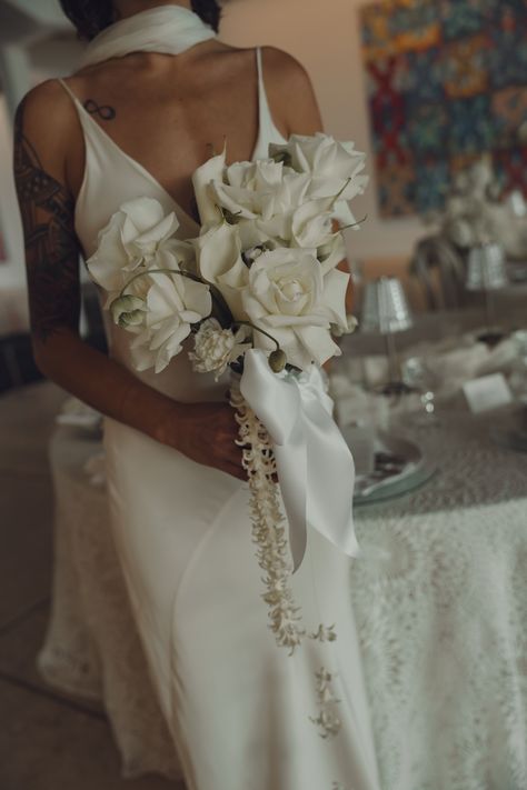 Elegant and minimal bridal bouquet featuring classic white roses, accented with a delicate ribbon and cascading florals. Perfect for brides embracing modern simplicity with a touch of romance. Bridal Bouquet Fall Cascading, Cascading Floral Bouquet, Modern Cascade Bouquet, Modern Bridal Bouquet Unique, Old Money Wedding Bouquet, Minimal Bridal Bouquet, White Cascade Bouquet, Minimalist Bridal Bouquet, Cascading Bouquet White