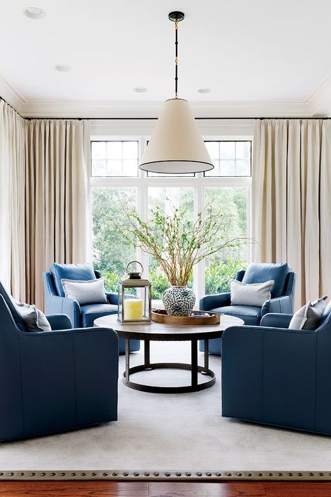 A seating arrangement features four blue-leather swivel chairs against a backdrop of subtly striped draperies; black hardware, a light fixture edged in black and upper windows detailed in graphite paint unite the space.  Interior Design: Kristin Peake Interiors Photo: Stacy Zarin Goldberg  #handdportfolio #top100designers  #kristinpeakeinteriors #design #interiordesign #dmvdesigners #dmvinteriordesigners #dmvinteriors #designinspo #inspiration #details #decor #livingroom 4 Chair Living Room Arrangement, Bar Lounge Room, Sitting Room Design, Living Room Arrangements, Living Vintage, Hearth Room, Living Room Update, Swivel Chair Living Room, Front Rooms