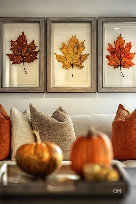 Cozy fall living room with neutral decor, featuring framed autumn leaves on the wall, earthy pillows on the couch, and pumpkins on the table. Playful Living Room, Fall House Decorations, Minimal Fall Decor, Cozy Fall Decor, Fall Wall Decor, Living Room Loft, Room Walls, Farmhouse Dining Room, Fall Decorations