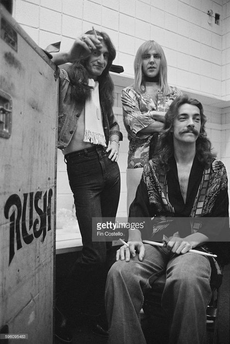 Canadian progressive rock group, Rush, backstage at the Civic Center in Springfield, Massachusetts, during the band's All The World's a Stage tour, 9th December 1976. Left to right: bassist Geddy Lee, guitarist Alex Lifeson and drummer Neil Peart. Rush Albums, Rush Concert, Permanent Waves, Geddy Lee, Rush Band, Alex Lifeson, Neil Peart, Rock And Roll Bands, Rock Groups