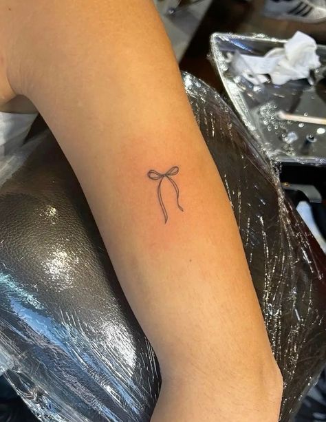 Bow Tattoo Behind Ear, Ribbon Tattoos Bow, Olivia Rodrigo Tattoo Ideas, Red Ribbon Tattoo, Graduation Tattoo Ideas, Red Bow Tattoo, Olivia Rodrigo Tattoo, Honeymoon Tattoo, Small Bow Tattoos