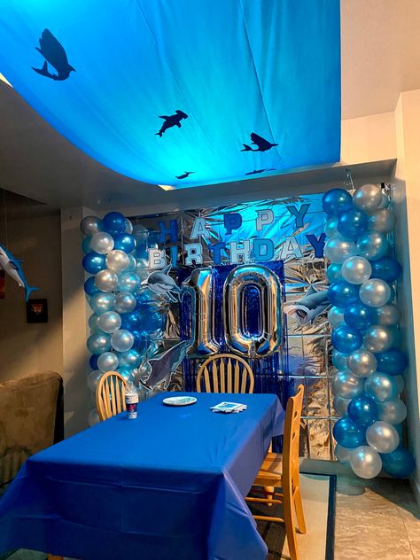 Shark theme birthday party decorations for my 10-year old son who loves SHARKS! Birthday sign, ocean silhouette and balloons all DIY by me. #shark #birthday #decor #diy #ocean Great White Shark Birthday Party, Shark Birthday Party Decorations Diy, Shark Birthday Party Aesthetic, Megalodon Birthday Party, Ocean Decor Party, Marine Birthday Theme, Megalodon Shark Birthday Party, Shark Party Ideas Decoration, Marine Biologist Birthday Party