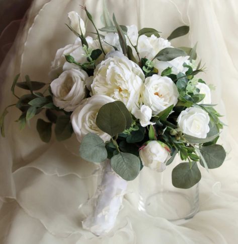 "BIANCA - is a boho wedding bouquet featuring eucalyptus foliage, white peony and garden roses.  White peonies, garden roses and lissianthus are nestled in eucalyptus, gum and ruscus foliage.  This silk bouquet uses teh eucalyptus and foliage to create an assymmetrical shape which is very boho, it is hand tied and looks like it was just picked from the garden, freshly gathered from a cottage garden.   This bouquet is a medium sized posy approx.  28cm (11\") in diameter.   Made from high quality, Ranunculus And Eucalyptus Bouquet, Wedding Basics, White Peonies Garden, Boho Bouquets, Bouquet Eucalyptus, Flowers 2023, Wedding Flowers Greenery, Bouquet Champetre, Navy Wedding Flowers