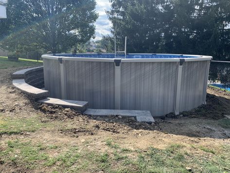 I had a retaining wall build around the half of my above ground pool that was dug into my sloped yard. We used versalock wall blocks for this project. Retaining Wall For Pool Sloped Backyard, Above Ground Pool Ideas Sloped Yard, Retaining Wall Above Ground Pool, Above Ground Pool Half In The Ground, Retaining Wall Around Pool Ideas, Retaining Wall For Pool, Retaining Walls Around Pools, Above Ground Pool Deck Ideas Sloped Yard, Above Ground Pool With Retaining Wall