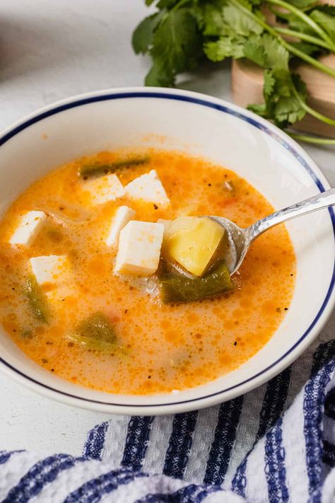 This caldo de queso is a simple cheese and potato soup that is sure to become a family favorite. This easy comfort soup recipe features some familiar ingredients like onions, tomatoes, and potatoes, as well as Mexican ingredients like long green chiles and queso fresco.rn Potato Poblano Soup, Mexican Cheese Soup, Queso Potato Soup, Mexican Potato And Cheese Soup, Mexican Cheese Soup Recipe, Mexican Potato Soup With Cheese, Green Chili Potato Soup, Mexican Potato Soup, Potato Soup Mexican Style