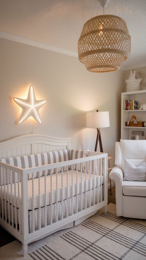 Aesthetic Beach Nursery theme with star fish light on wall, rattan hanging lamp, white crib and cozy parent chair. Beach Nursery Ideas, Coastal Baby Room, Boho Beach Nursery, Sunset Nursery, Beach Themed Nursery, Beach Theme Nursery, Sea Animal Nursery, Ocean Theme Nursery, Calming Nursery